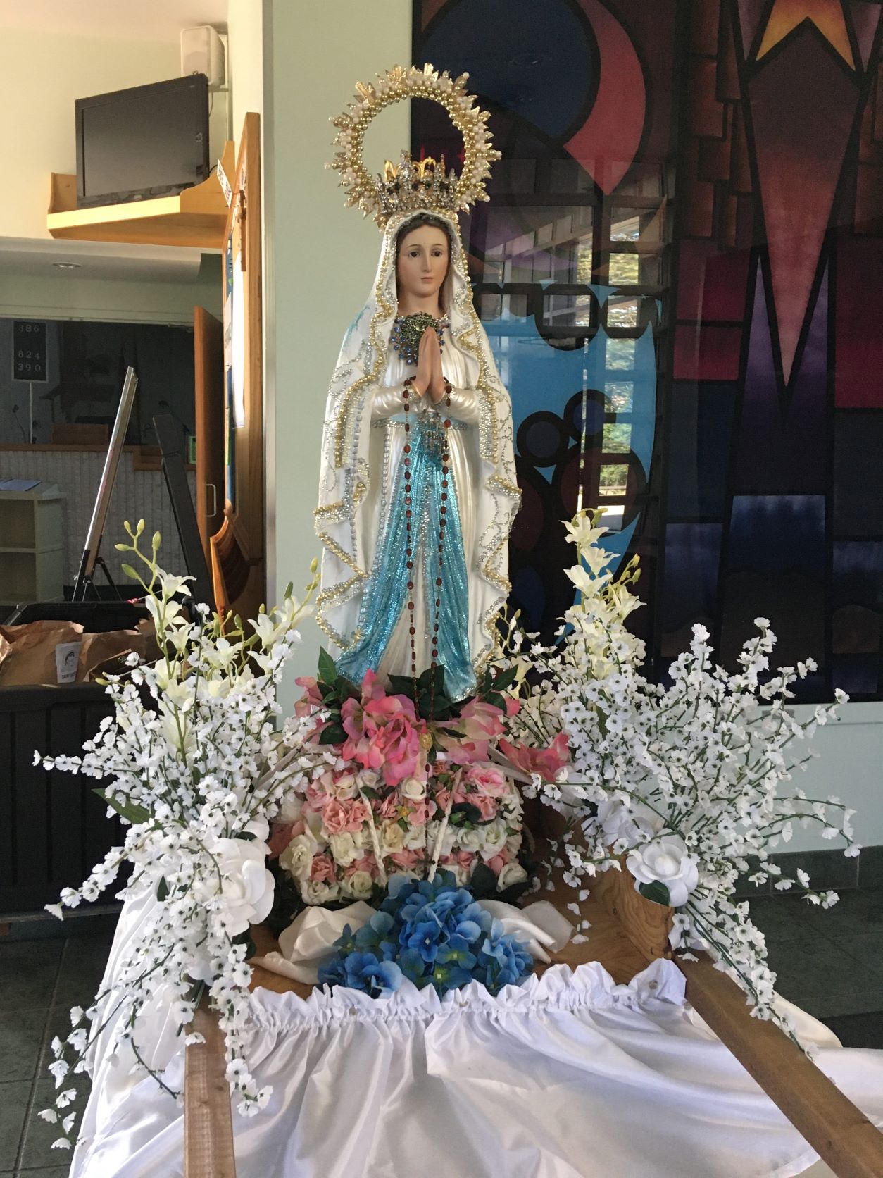 Statue of the Blessed Virgin surrounded by flowers